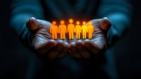 Glowing orange paper cut figures in cupped hands against dark background symbolizing community care, unity, leadership and human resources management.