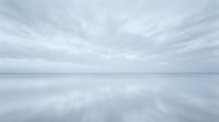 Serene coastal landscape with calm water reflecting overcast sky, ideal for backgrounds, web design, and editorial projects.