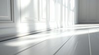 Bright sunlight streaming through windows casting dramatic shadows on white wooden floor panels and walls, creating minimalist architectural interior scene.