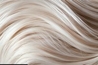 Flowing platinum blonde hair texture with gentle waves and highlights creating natural movement pattern, close-up view for hair and beauty industry backgrounds.