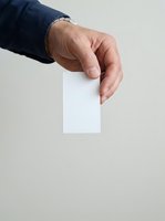 Male hand holding blank white card against neutral background, suitable for business, voting, membership, or promotional mockup designs.