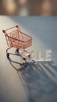 Mini rose gold shopping cart beside glossy SALE letters on a gray surface with soft shadows, perfect for retail and discount promotions.