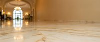 Elegant marble floor with geometric patterns in luxurious hotel lobby interior with warm lighting and classical architecture for premium hospitality design.