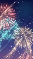 Spectacular fireworks display bursting with vibrant pink, turquoise and golden colors against deep blue night sky for celebration events and holidays.