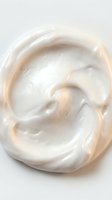 Creamy white cosmetic product with smooth swirled texture, isolated on white background. Suitable for skincare, beauty, and cosmetics marketing materials.