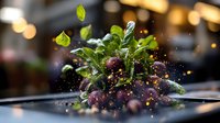Fresh mixed berry salad with mint leaves and sparkling water droplets on elegant black plate in upscale restaurant setting with warm bokeh lighting.
