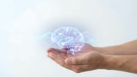 Hands holding a glowing digital brain hologram with connected icons, symbolizing artificial intelligence and future technology concepts.
