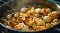 Caramelized pearl onions simmering in a savory broth, creating a rich golden-brown color with steam rising from the pan, ready for gourmet cooking.