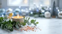 Spa wellness scene with burning candle, eucalyptus leaves and pink salt crystals on white surface with blurred holiday lights background for relaxation.