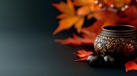 Ornate bronze bowl with decorative patterns surrounded by vibrant autumn maple leaves and acorns creating warm seasonal atmosphere for fall decor projects.