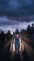 Hooded figure with glowing red heart standing among crowd on misty road at dusk, symbolizing hope, spirituality, and inner light for conceptual and editorial projects.