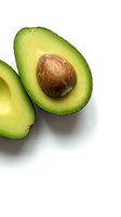 Fresh ripe avocado halves with pit isolated on white background for healthy cooking and nutrition content.