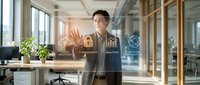 Young Asian businessman in modern office interacting with holographic business analytics icons and data visualization interface for digital transformation.