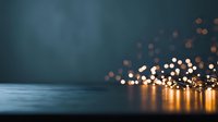 Glowing string lights creating warm bokeh effect against dark blue background, perfect for holiday or celebration designs.