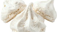Meringue cookies dusted with powdered sugar, isolated on white background, ready for bakery, dessert, and confectionery design projects.