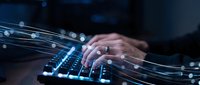 Professional hands typing on illuminated keyboard with glowing digital network connections and data streams for technology and cybersecurity concepts.