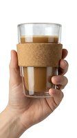 Hand holding a double-wall glass cup with cork sleeve filled with latte coffee, isolated on white background.
