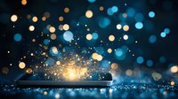 Glowing smartphone screen with magical light sparkles and bokeh effects against dark background, creating ethereal atmosphere for technology concepts.