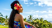 Woman with long dark hair wearing tropical flower lei and colorful swimwear gazes toward palm trees and blue sky, evoking summer vacation and island getaway vibes.