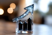 Crystal glass business growth chart with sparkly silver arrow pointing upward against blurred bokeh background, symbolizing success and financial progress.