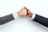 Business partners fist bumping on white background, showing collaboration and agreement between diverse professionals in formal attire, isolated photo for business concepts.