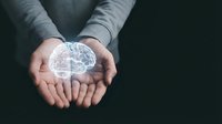 Caucasian male hands holding glowing digital brain hologram against dark background, representing artificial intelligence, innovation, and technology concepts for business and healthcare applications.