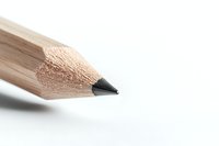 Sharp wooden pencil tip close-up on white background, showing detailed texture and graphite point in minimalist composition, isolated for creative and educational use.