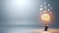 Glowing light bulb with financial icons and symbols representing innovation, investment ideas, and business growth concepts on modern background.