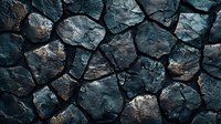 Dark stone wall with irregular shaped rocks creating natural pattern and texture. Rough surface of gray and blue stones with deep shadows between them.