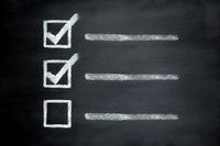 Checklist with two completed tasks and one empty box drawn in chalk on blackboard background, useful for planning, productivity, or education.