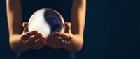 Young woman with medium skin tone holding glowing crystal ball, fortune teller or mystical practitioner, magical light effect for spirituality and divination concepts.
