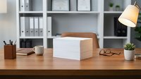 Clean modern office workspace with white paper stack on wooden desk, organized shelving, warm lighting and minimal decor for productivity and business concepts.