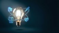 Glowing light bulb with digital healthcare icons and medical symbols on dark background representing innovation in medicine and technology solutions.