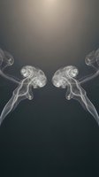 Abstract white smoke swirls creating symmetrical patterns on dark gradient background for creative design projects and artistic compositions.