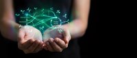 Female hands cupping glowing green network connections and data visualization hologram against dark background for technology presentations.