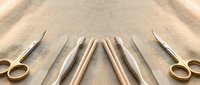 Surgical and dissection tools arranged symmetrically on burlap fabric, including scissors, scalpels, and probes with copy space.