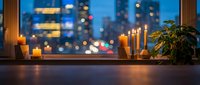 Cozy evening windowsill with burning candles overlooking blurred city lights at dusk. Warm ambient lighting creates peaceful atmosphere for relaxation.
