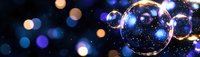 Magical soap bubbles floating in dark space with blue and golden bokeh lights creating dreamy atmospheric effect. Macro photography with reflections and sparkles.