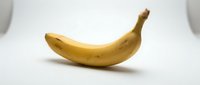 Single ripe yellow banana isolated on white background, ready for design use in food, nutrition, and healthy eating projects.