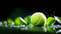 Tennis ball with water droplets on reflective surface against dark background, creating dynamic sports composition with splashing water effect.