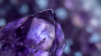 Purple amethyst crystal close-up with natural facets and inclusions against soft bokeh background for healing and spiritual wellness concepts.