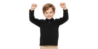 Cheerful Caucasian boy in black polo shirt raising arms in victory gesture, expressing joy and achievement against white background.