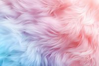 Soft pastel colored fur texture in pink, blue and purple hues creates dreamy abstract background with fluffy, furry surface for creative design projects.