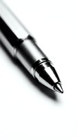 Close-up of silver ballpoint pen tip on white background, business writing instrument for office work and professional documentation.