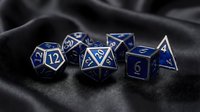 Blue metal polyhedral dice set with silver numbers on dark fabric background for tabletop gaming and role-playing adventures.