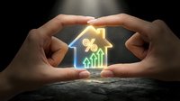 Hands protecting glowing house with percentage symbol and upward arrow representing mortgage rates, real estate investment growth and property protection.