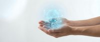 Hands holding glowing digital globe with blue light effect, representing global connectivity, technology, and worldwide communication for business and innovation concepts.