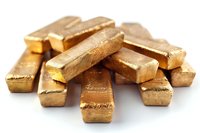 Stack of pure gold bars on white background, precious metal investment bullion showing texture and luster of refined gold ingots, financial wealth concept.
