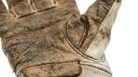 Worn cowboy boot with distressed leather and cream-colored ribbed shaft, showing aged texture and weathered details suitable for western, country, and rustic design projects.