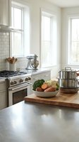 Bright, airy kitchen with white subway tile backsplash, stainless steel appliances, and fresh vegetables in a bowl on wooden cutting board near countertop.